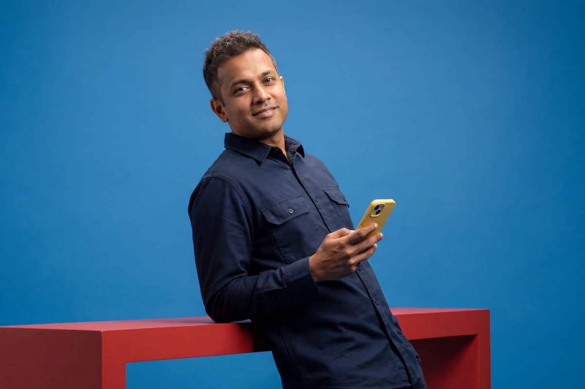 man holding a phone on a blue background